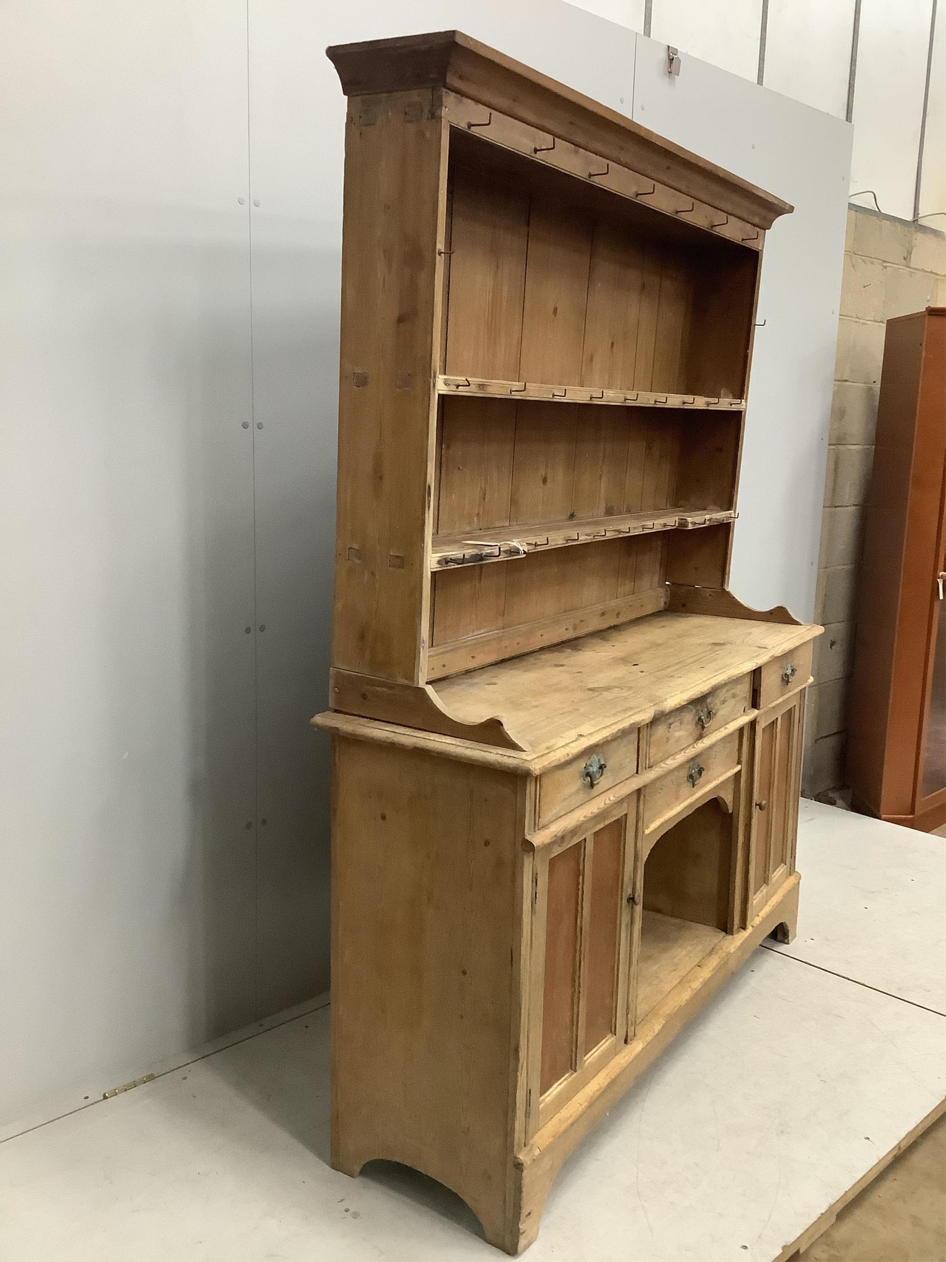 A 19th century and later pine dresser with boarded rack, width 154cm, depth 44cm, height 192cm. Condition - fair